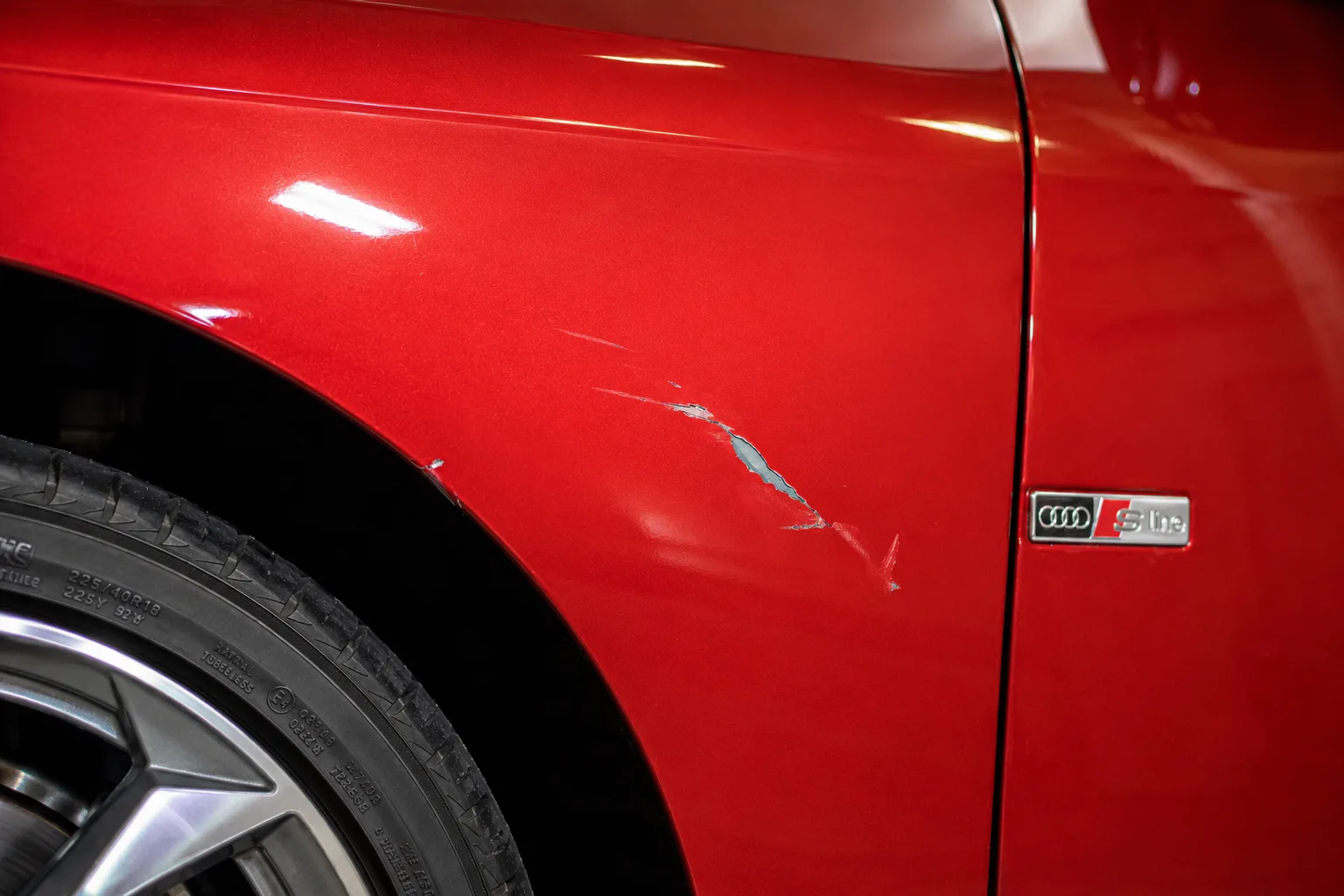 Before: deep scratch removed from a red Audi fender in Albany NY — Capital Region